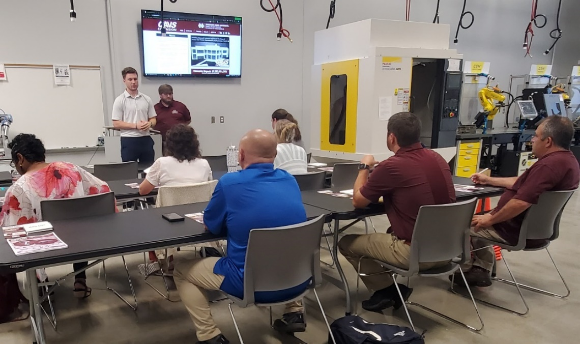 Carver Middleton, CAVS, and Jonathan Howell, CAVS-Extension, explain autonomous mobile robot technologies to a group of CTE Instructors and Career Coaches at EMCC