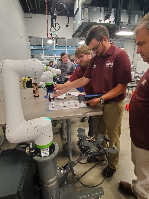 CTE Instructors and Career coaches programming a Cobot
